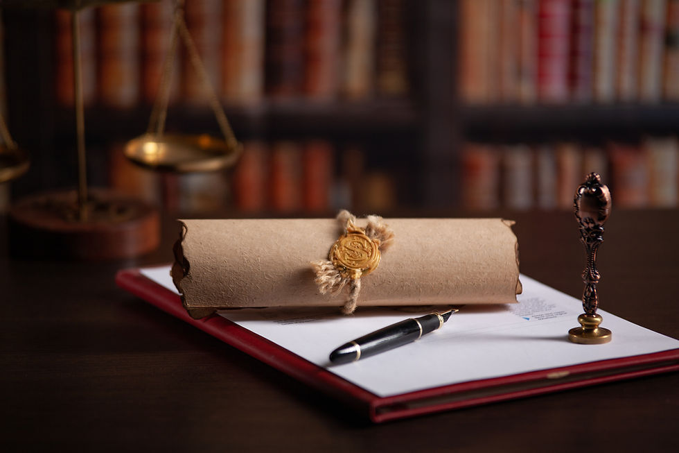 Document rolled up sitting on top of desk with a pen and stamp.