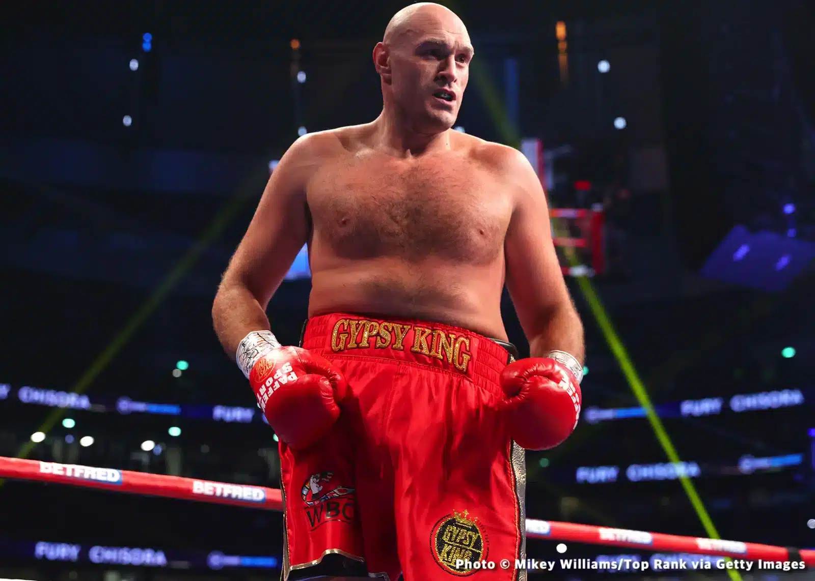 Tyson Fury in a boxing ring, looking contemplative, amidst discussions on his performance and future in boxing as per Carl Froch's observations.