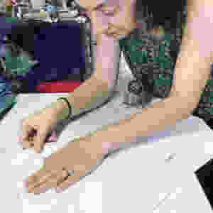 Pulling paper from the drying sheet, art class, handmade paper art class