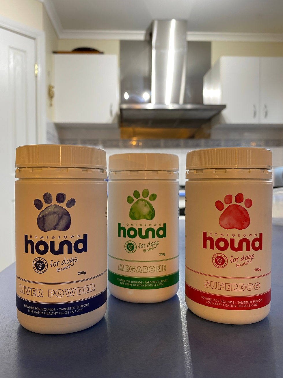 Three bottles sit on the kitchen bench