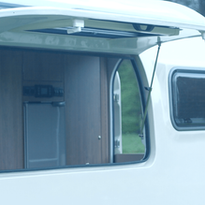 The large side hatch of the Campod Caravan in the open position, allowing fresh air in and providing great views of the surroundings.