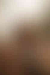 guy picking up and holding girl over his shoulder. the girl is smiling and showing her engagement ring off to the camera. The photo is candid, cozy, and romantic. The guy is walking in the middle of the road with snow, trees, and mountains in the background. engagement photos atheckerboard mesa in zion national park