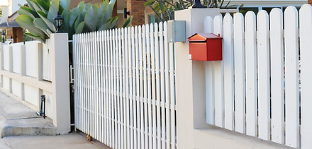 White picket fence in front of house