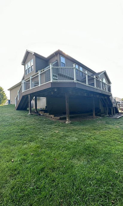A large, elevated second-story deck with brown railings, built on a sloped yard in Pottstown, PA.