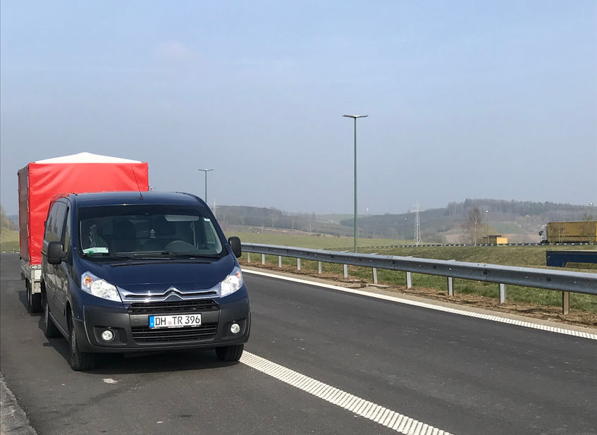 Lieferwagen auf der Autobahn mit Anhänger
