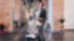 A woman in a wheelchair looking at camera smiling