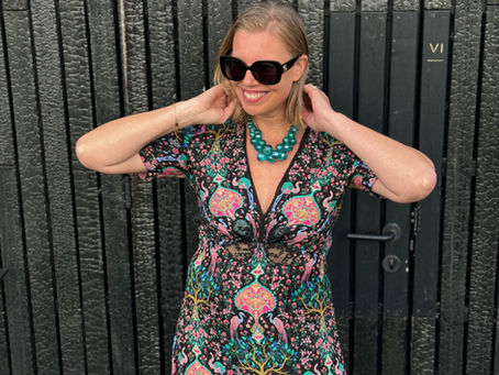 A woman with a green bold statement necklace