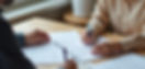 High angle view of a community support worker assisting a client with paperwork