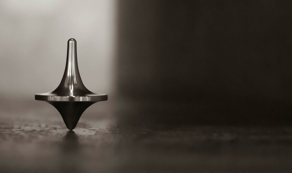 Spinning top balancing in the dark