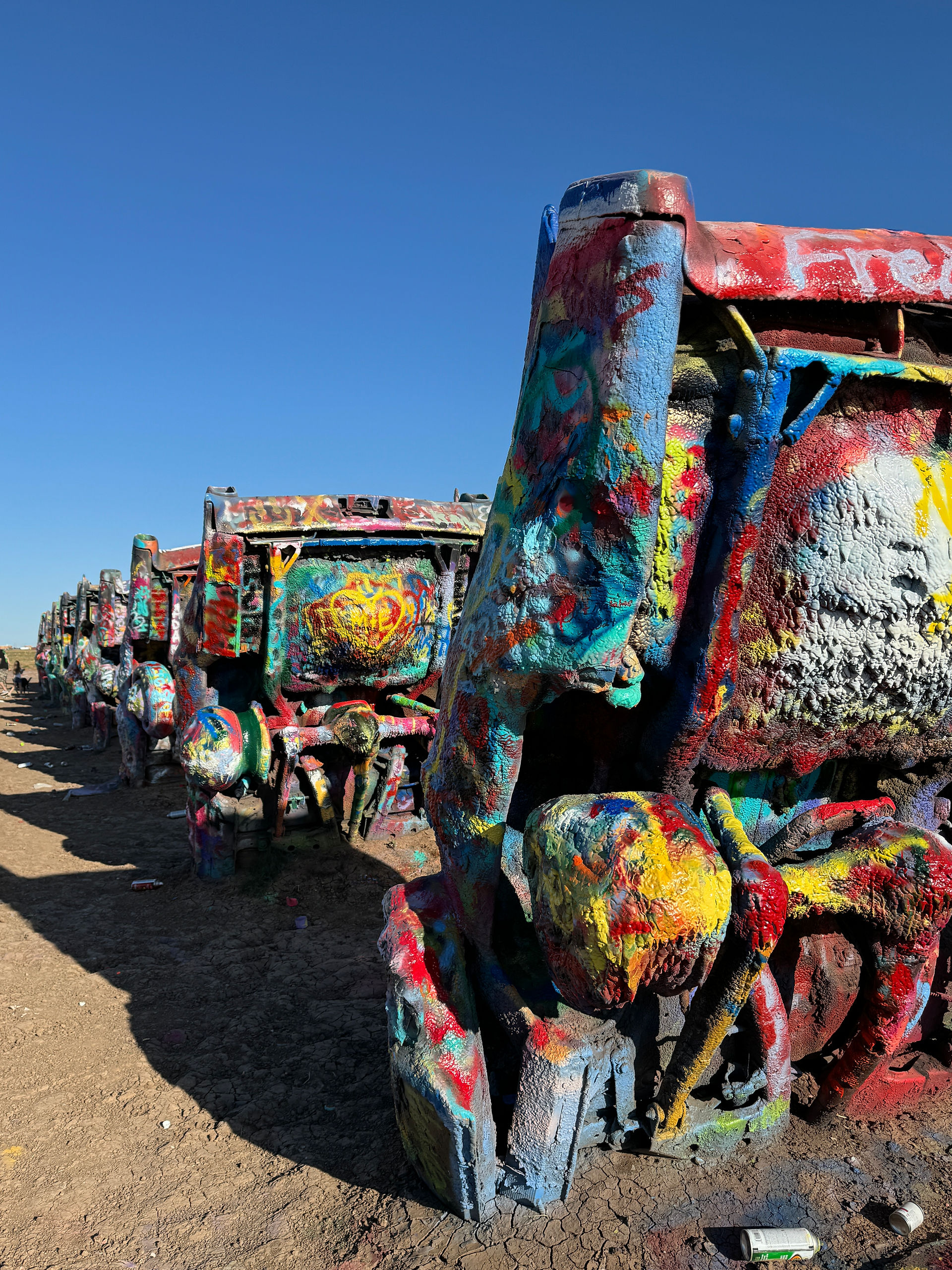 Row of spray painted sedans at Cadillac Ranch in Texas