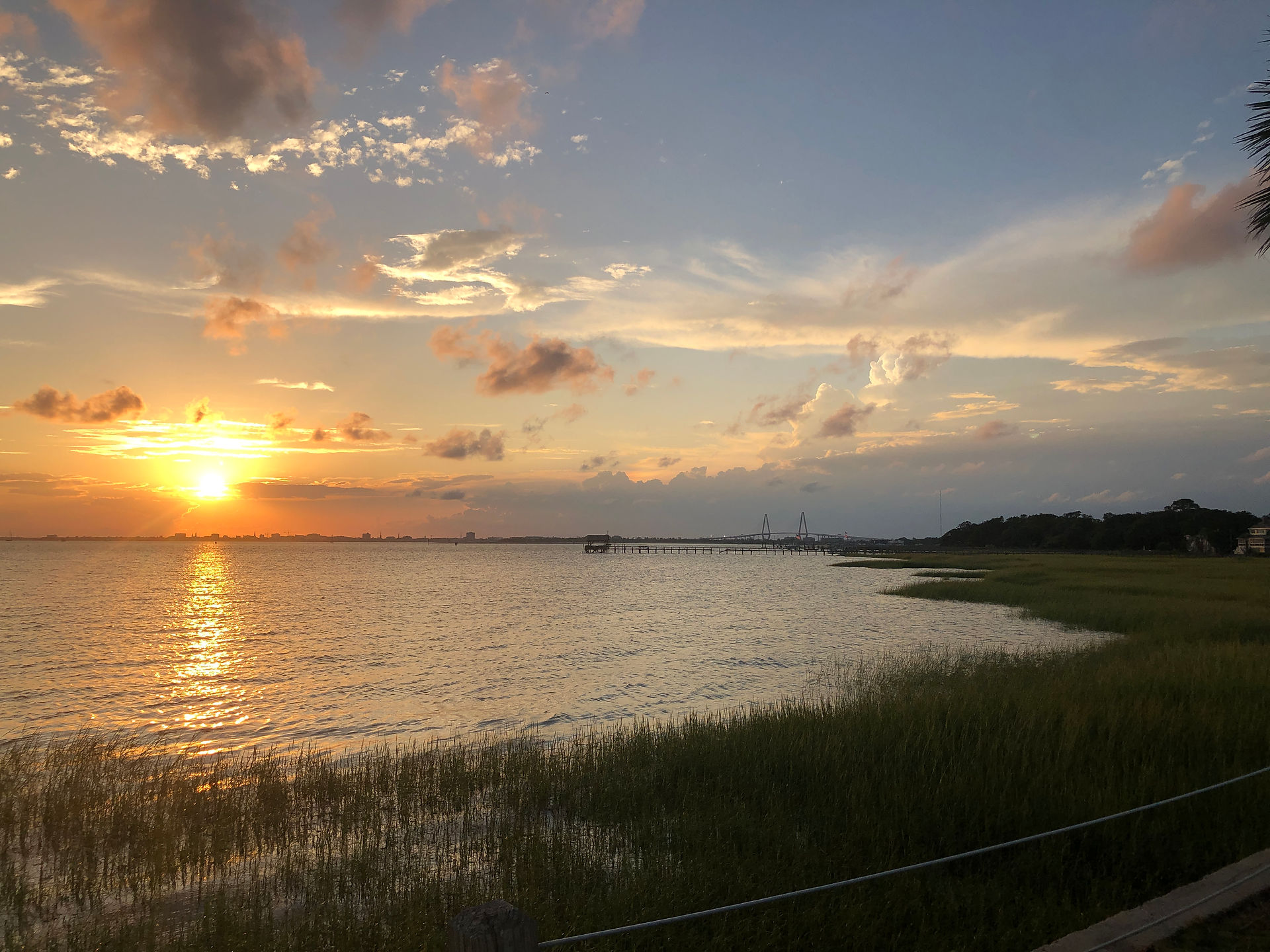 View from Pitt St Park of sunset over Charleston Harbor