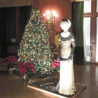Vintage dress exhibited next to a Christmas tree at the Biltmore House