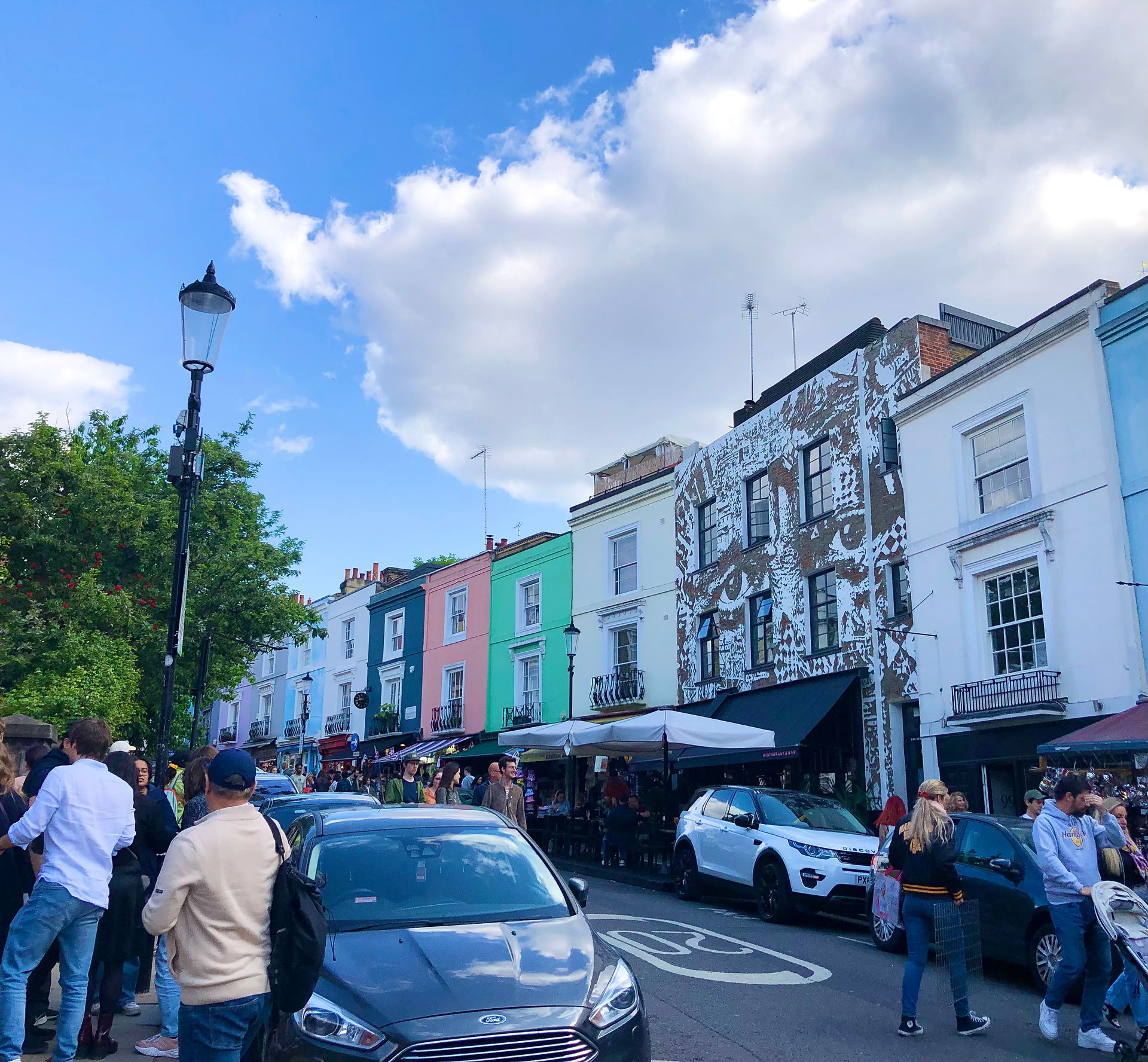 Colorful houses and a mural along Portobello Road in Notting Hill, London