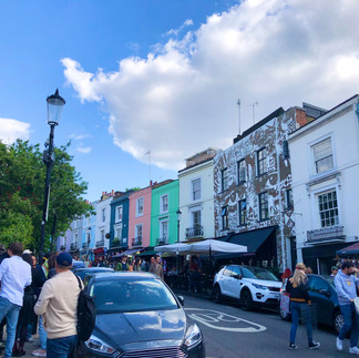 Colorful houses and a mural along Portobello Road in Notting Hill, London