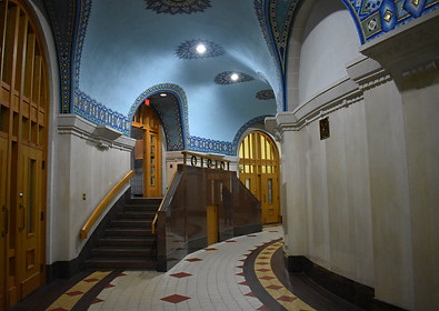 hallways with blue ceilings and gold doors