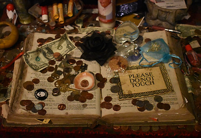 voodoo altar with coins on a book