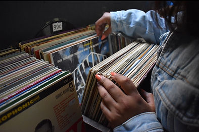 hands flipping through records