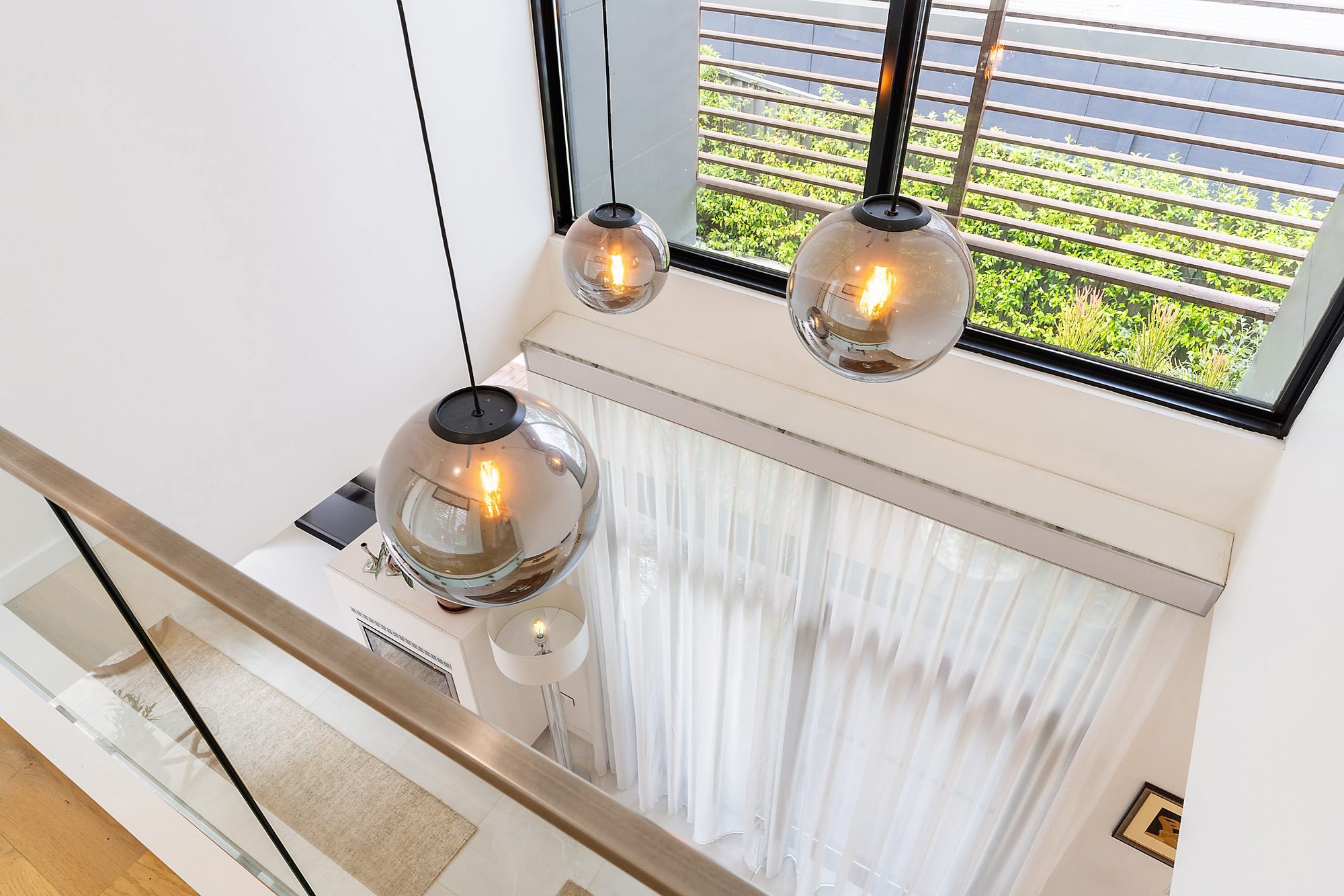 Stair void with smoked glass pendant lights