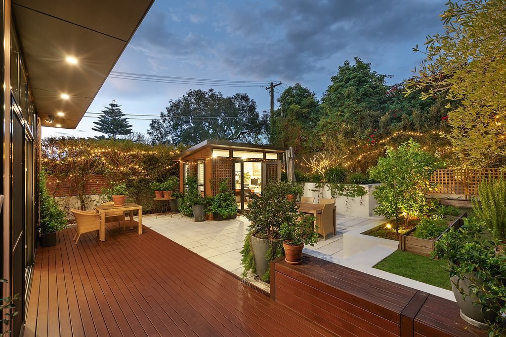 Timber deck and landscaped courtyard at dusk