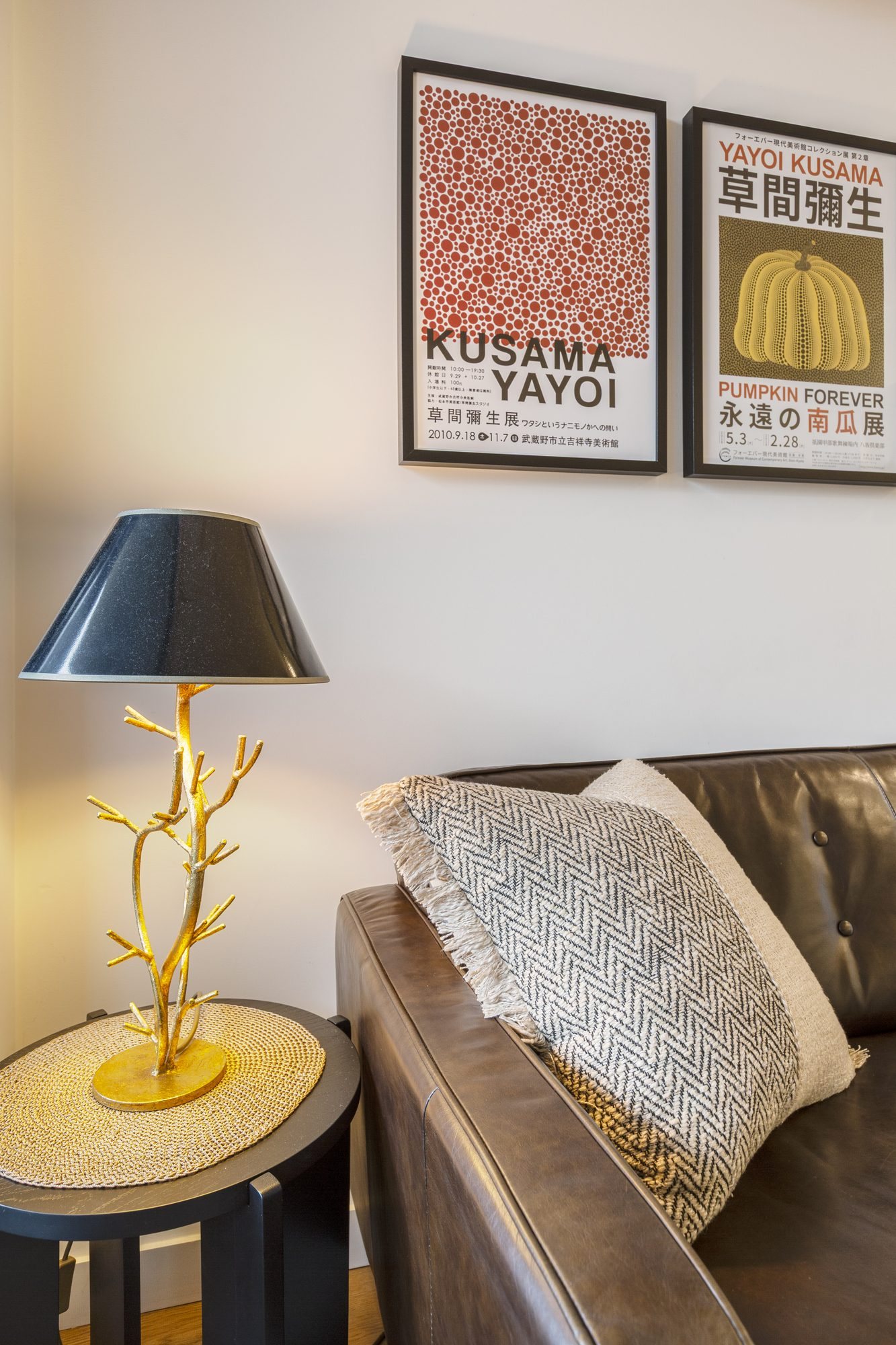 Living room detail with brass table lamp and leather sofa