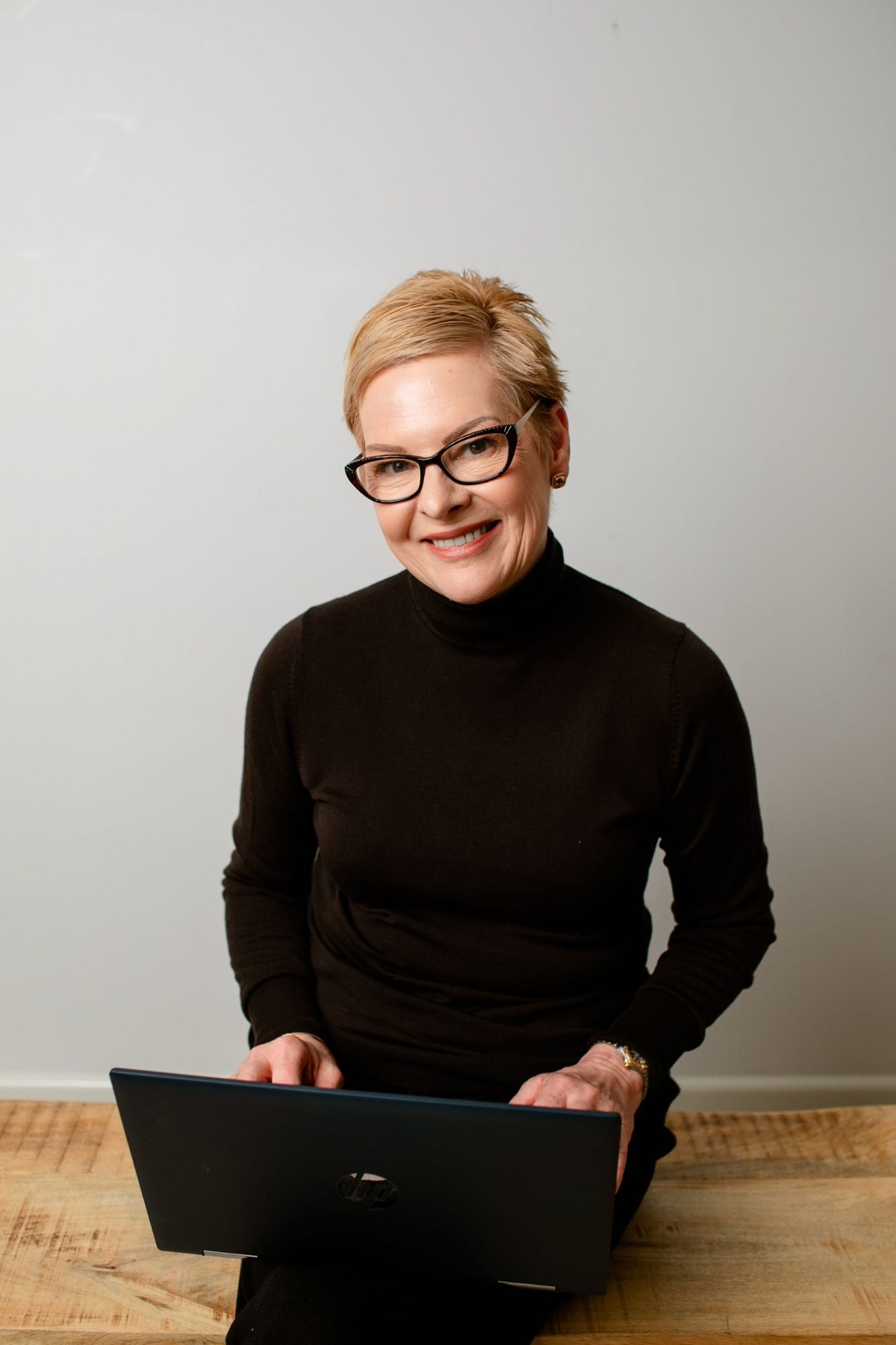 Ewa Doherty of Tablelands Interior Design working on a laptop