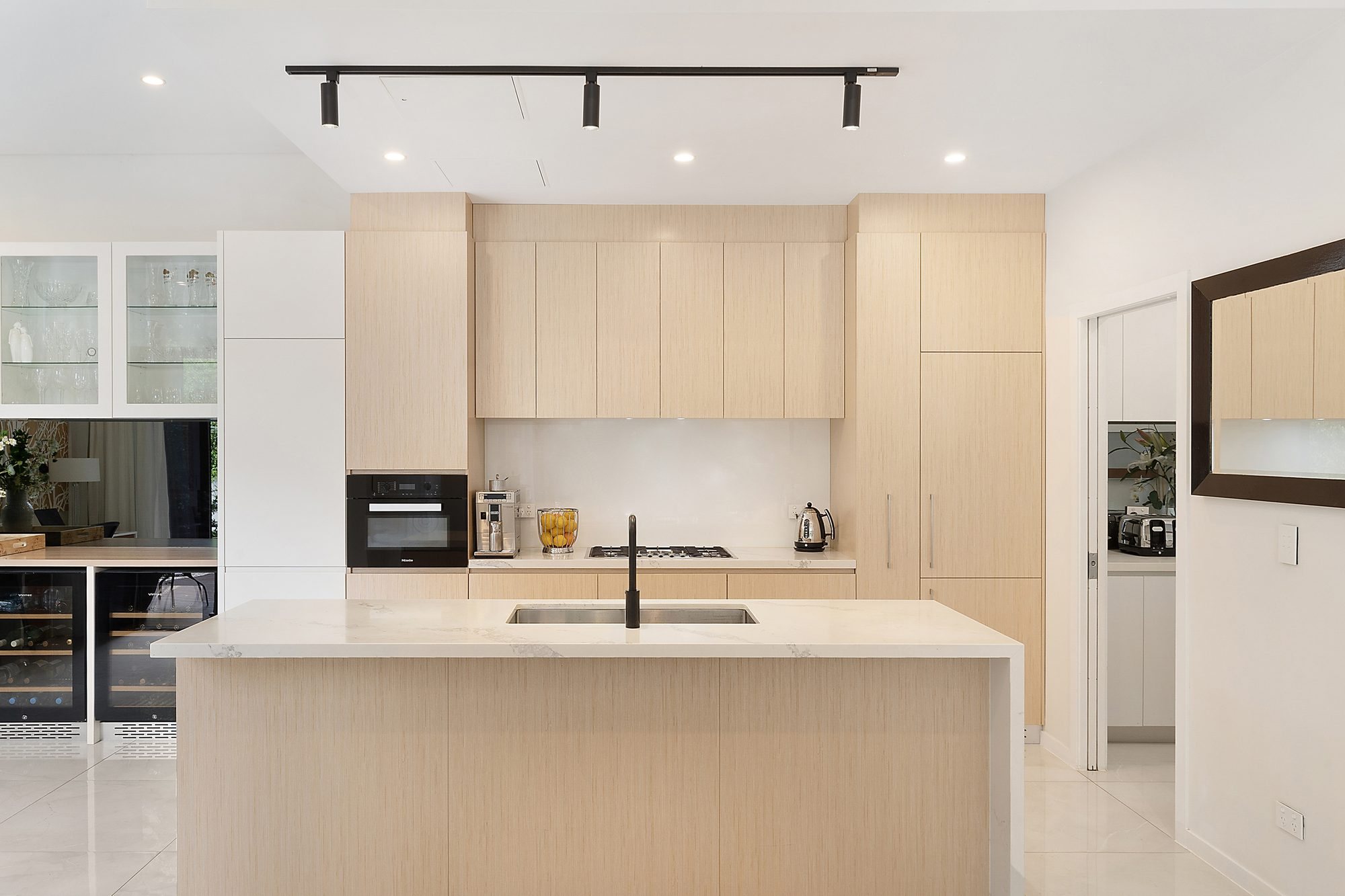 Kitchen with stone island bench and full-height joinery