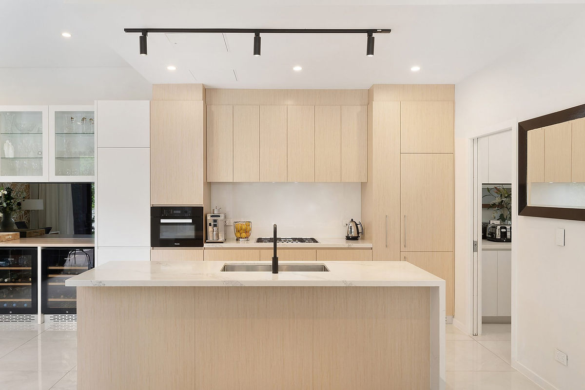 Kitchen with stone island bench and full-height joinery