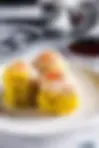 Three siu mai dim sum dumplings served in a traditional bamboo basket in Georgetown, Penang, Malaysia.