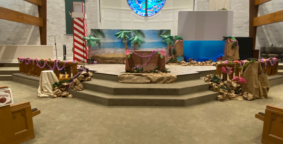 The front of MUMC's sanctuary decorated to look like a beach with a lighthouse to the left