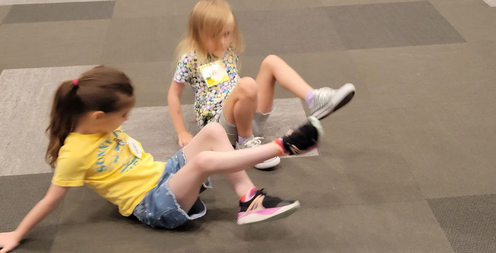Two little girls crab walking during games