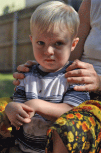 A teacher resting her hands on a child’s shoulders