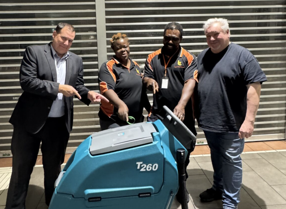 Quality Control Manager discussing cleaning requirements with a client during an onsite onboarding visit.