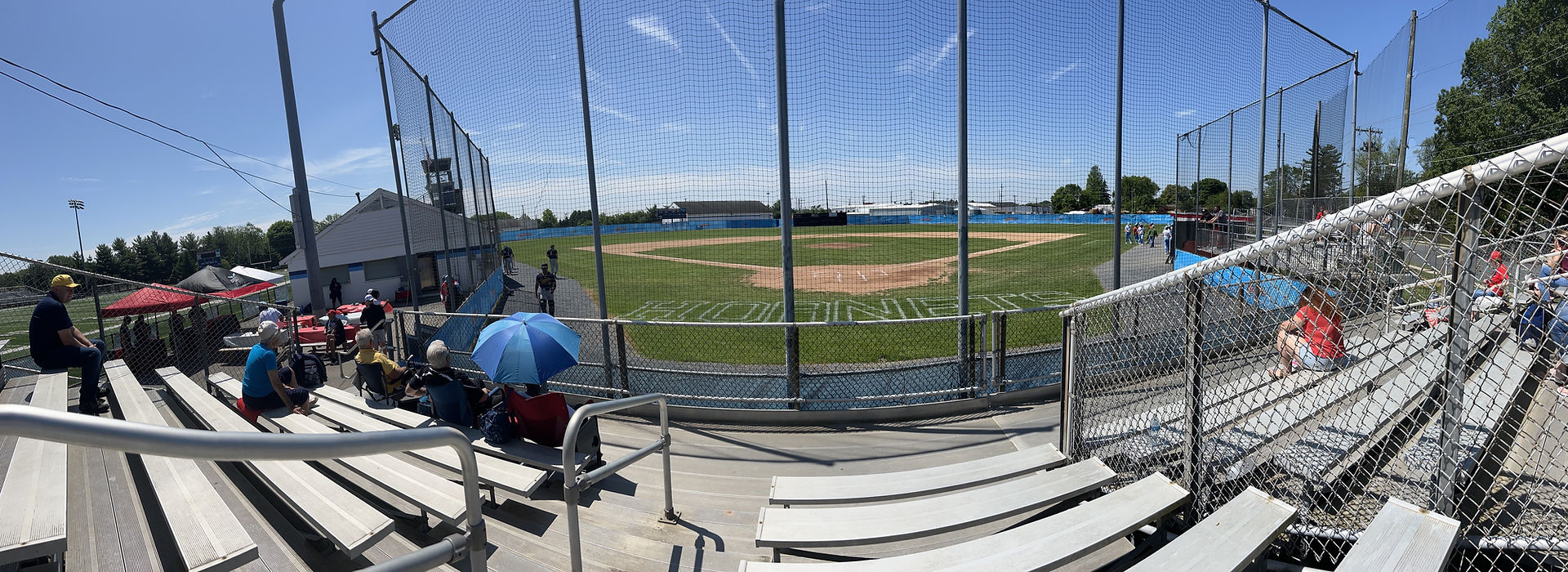 A panorama of Bob Reed Field, the Hornets logo visible behind home plate and fans in the stands