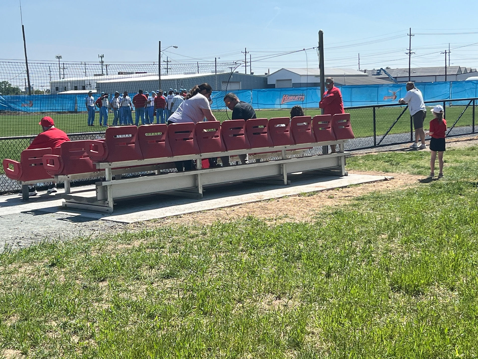 A small section of red chairback seats overlooking Bob Reed Field