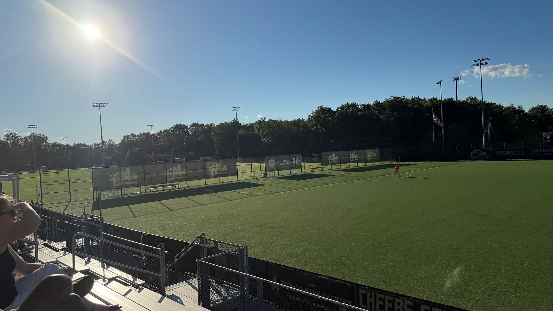 The sun sets over the west goal at RavenTek Park, brutally glaring.