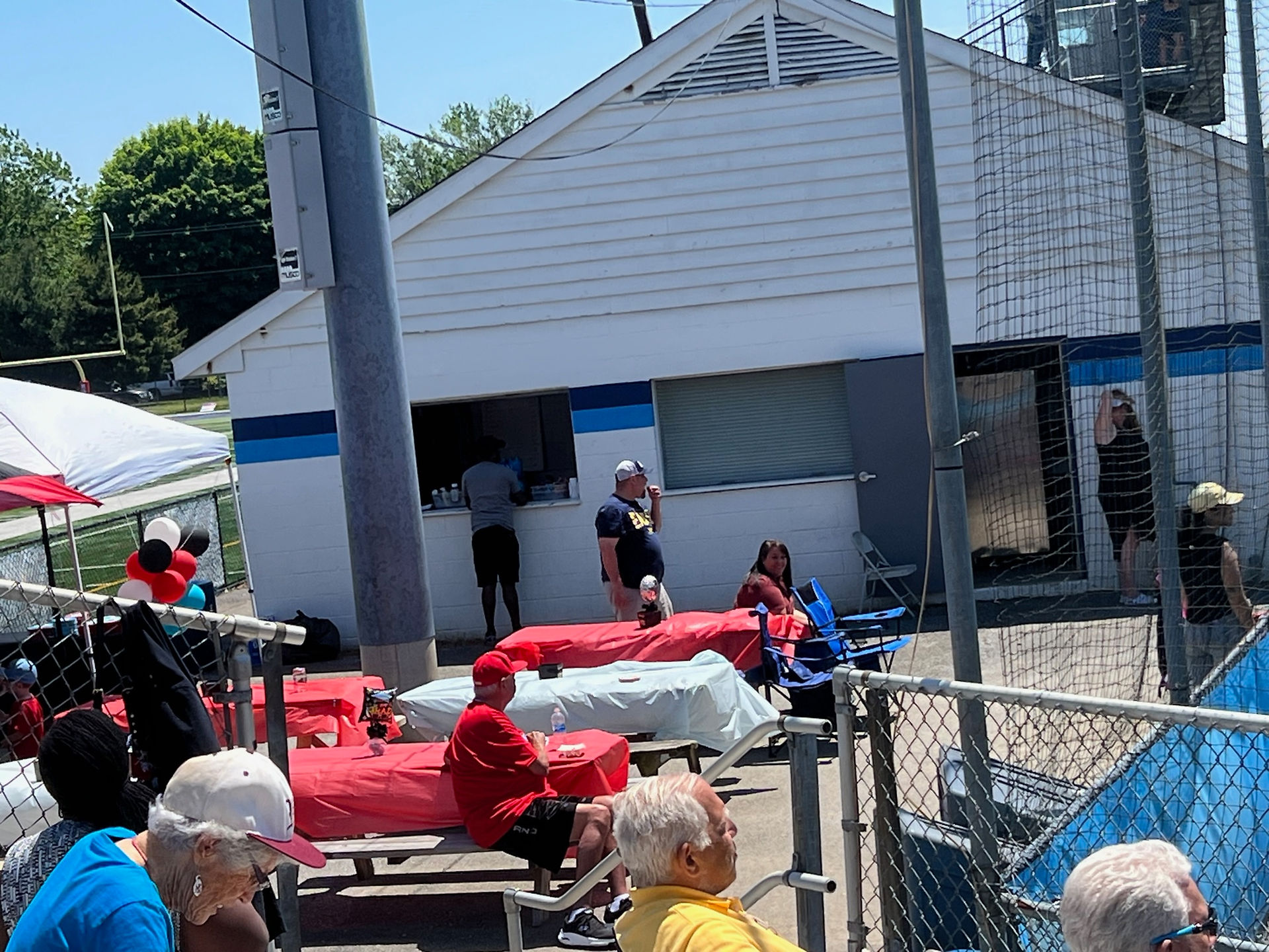 The concession stand at Bob Reed Field, and picnic tables with tablecloths in the Hornets' colors of red and powder blue