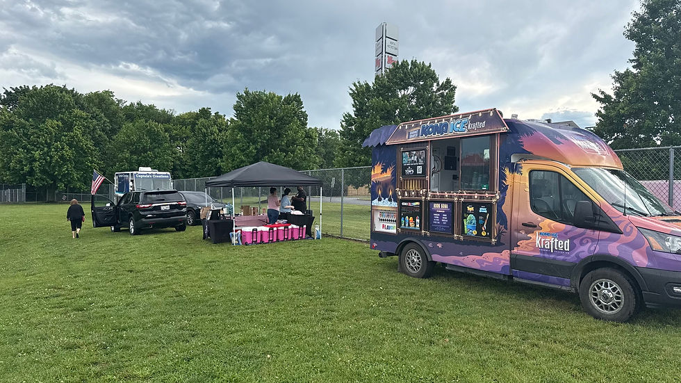 The food area at a Hub City FC game, featuring two food trucks and a tent selling dirty sodas.