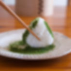 Garnishing the rice ball with dried seaweed.