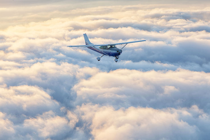 aircraft flying over cloud