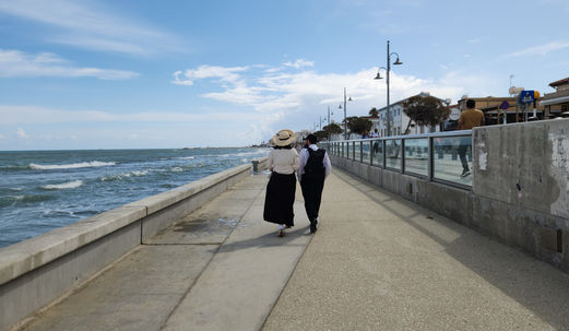 A Jewish couple walks along the Mediterranean shoreline in Larnaca