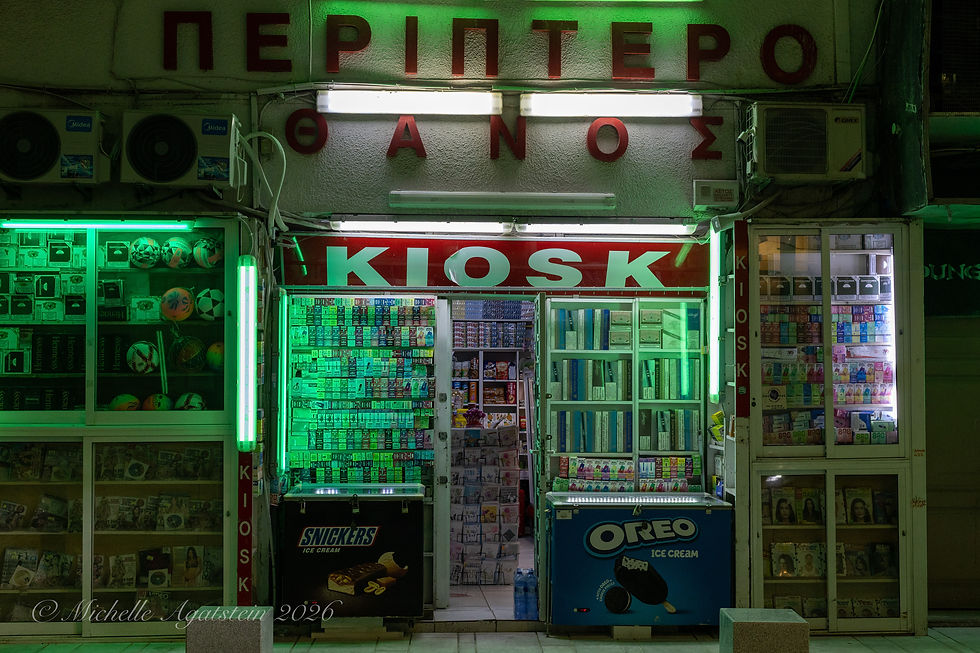 A convenience store in Larnaca, Cyprus, glows green in the evening