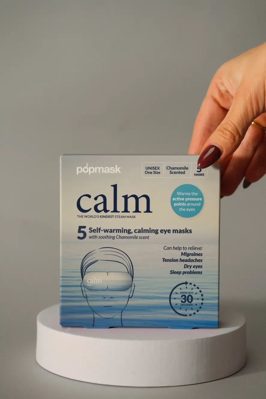 Thumbnail: Woman's hand holding Popmask calm eye masks; Self-warming, calming, chamomile scented; Mellofina