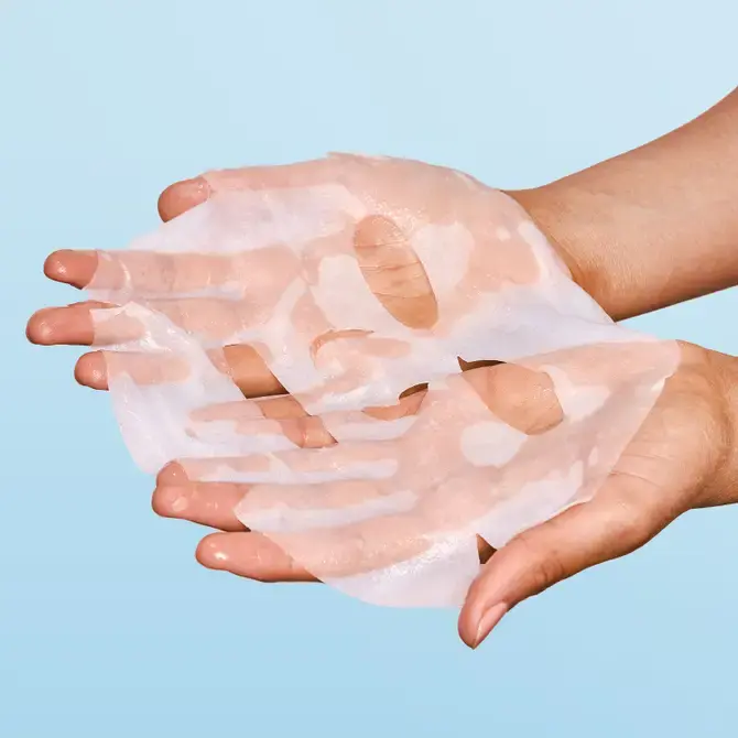Thumbnail: Hands holding a translucent face mask, ready to apply. Mellofina for skin care.