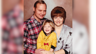 Family portrait: Smiling man in plaid shirt, woman in patterned blouse, and child in yellow dress with red bow, neutral background.