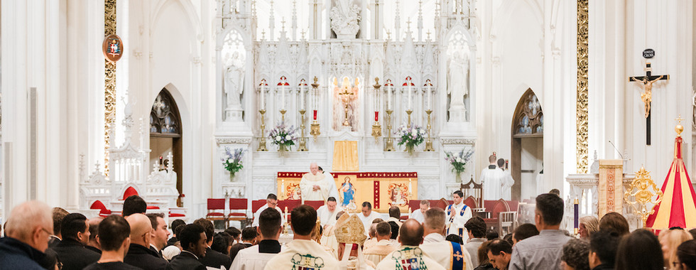 A congregation gathers in a grand, ornate church. Priests in robes conduct a ceremony near an intricately detailed altar. Moods of reverence prevail.