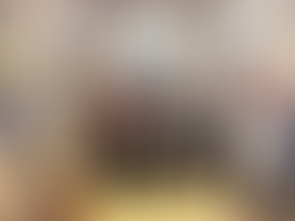 A group of adults and children pose on church steps. The setting is ornate with arches and religious symbols. The mood is joyful and celebratory.