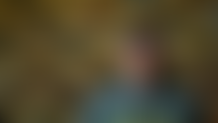 A man with a beard wears a "Colorado" hoodie and cap, standing in front of a wooden wall displaying various hats. Mood: casual.