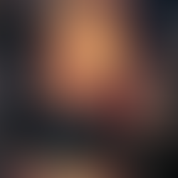 Ornate church interior with a large gathering of people. Red and gold decor dominates. Illuminated altar and religious art visible.