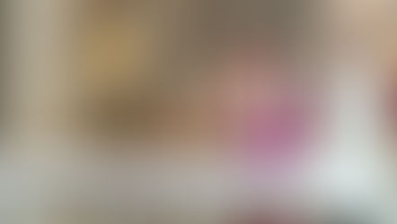 A religious ceremony with clergy in purple and white robes, praying at an altar with lit candles in an ornate church setting.