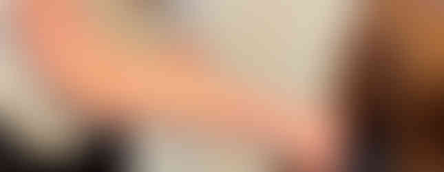 Stylist cuts a girl’s long red hair, which is sectioned into pigtails for donation.